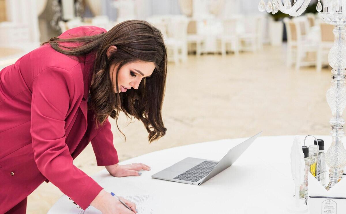 Event manager writing on paper in banquet hall