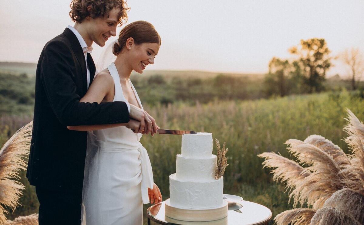 Young couple cutting their wedding cake