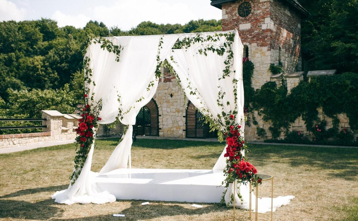 Wedding altar made of square curtains stands on the backyard