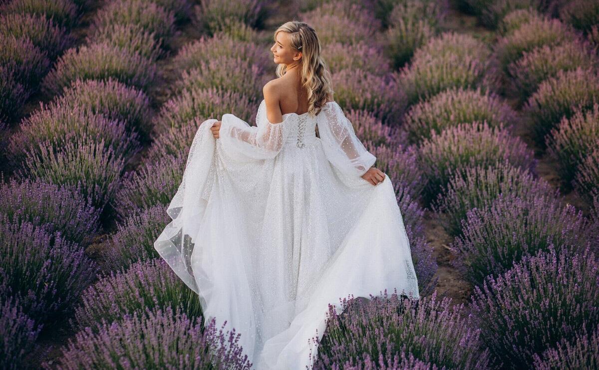 Beautiful woman in wedding dress in lavender field